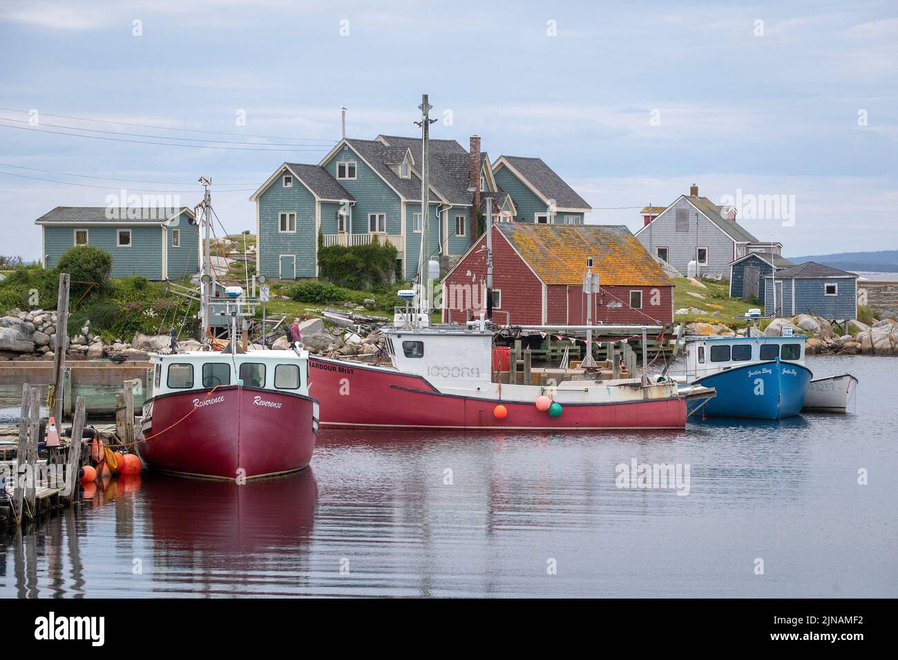 People walk around Peggy's Cove lighthouse in Peggy's Cove, Nova Scotia on Friday July 8, 2022. Stock Photo