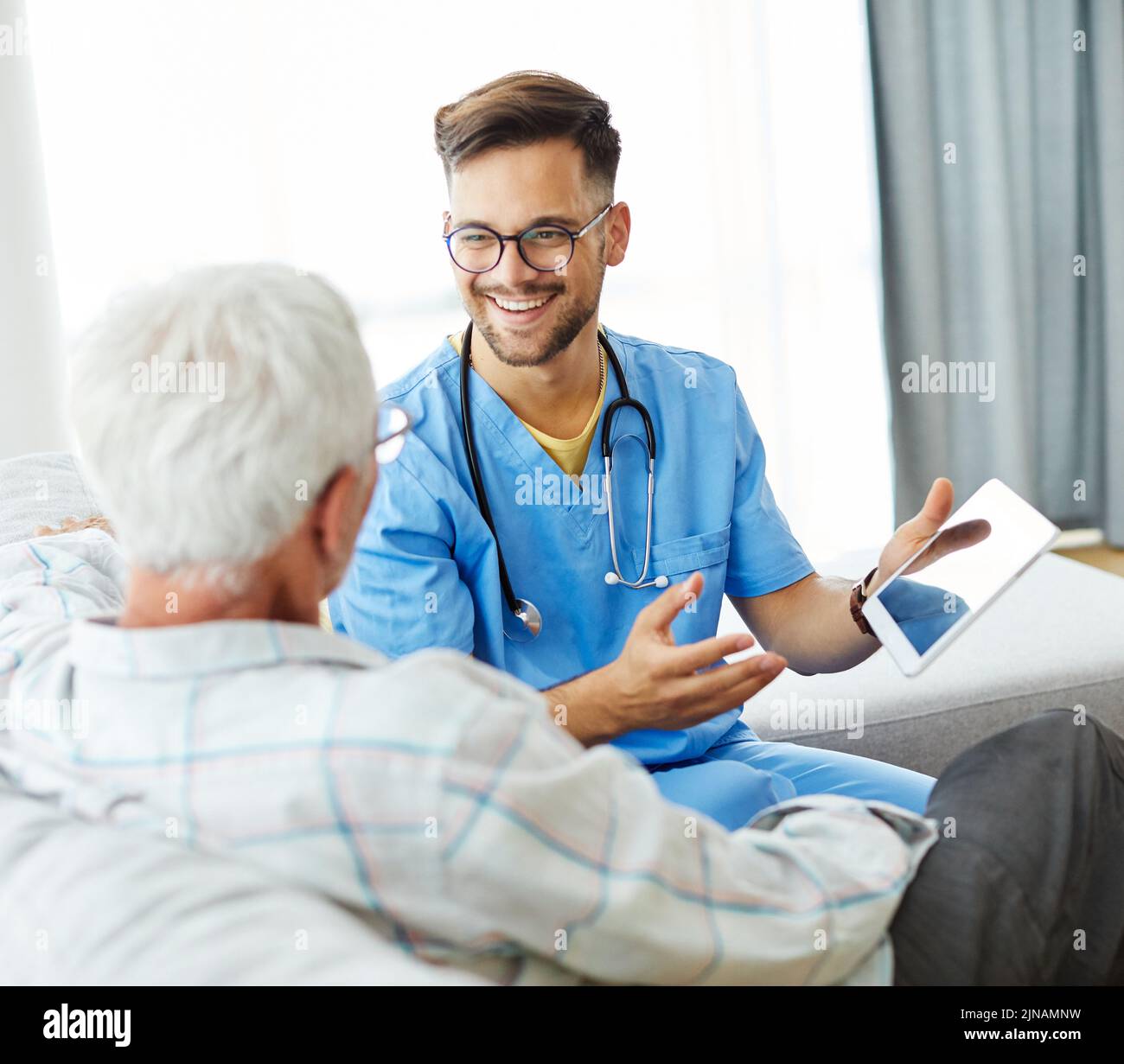 nurse doctor senior care caregiver help assistence retirement home tablet computer technology occupation Stock Photo