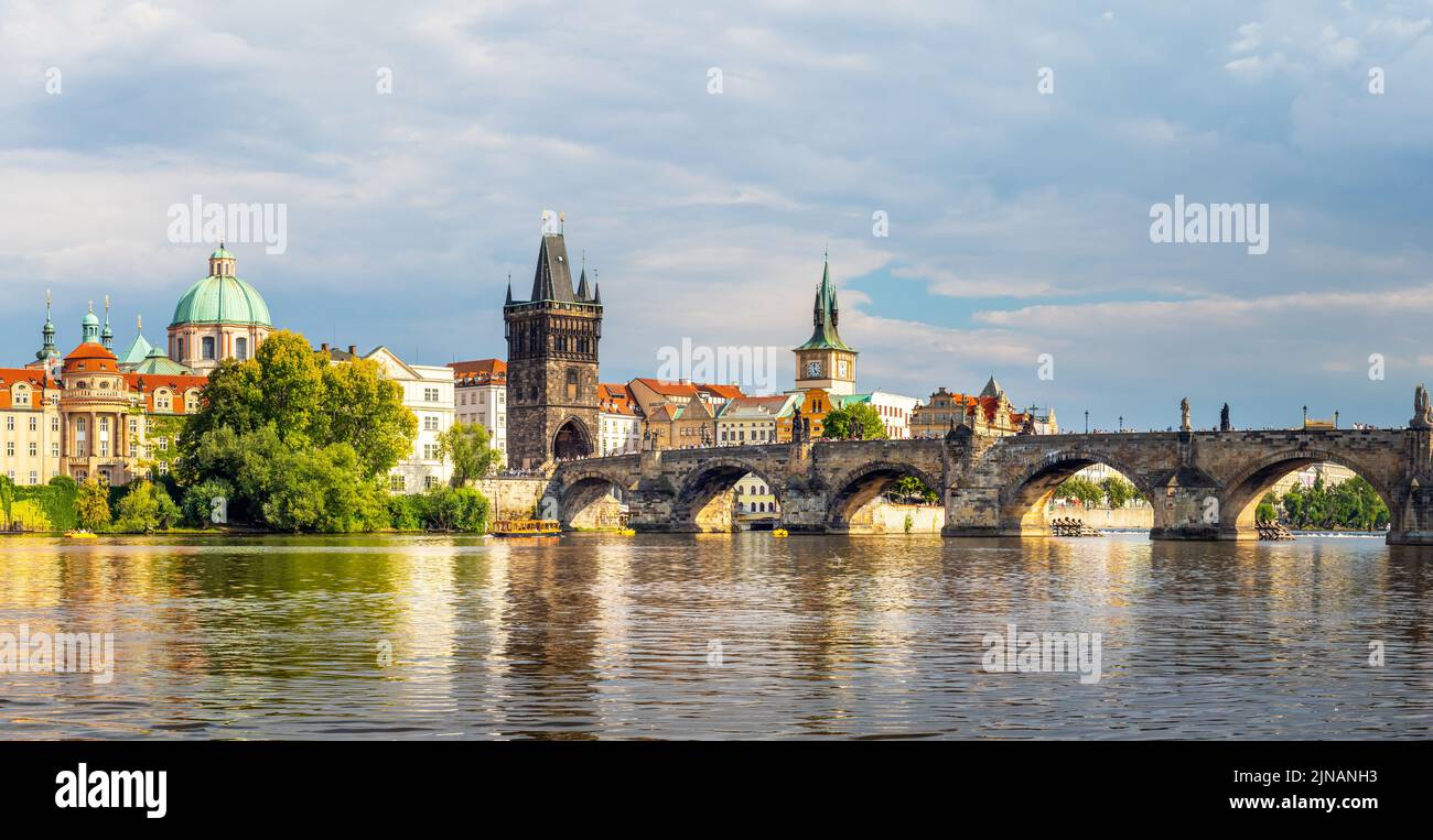 waterfront view across the river Vltava to the Charles Bridge and Old Town Bridge Tower, Prague, Czech republic Stock Photo