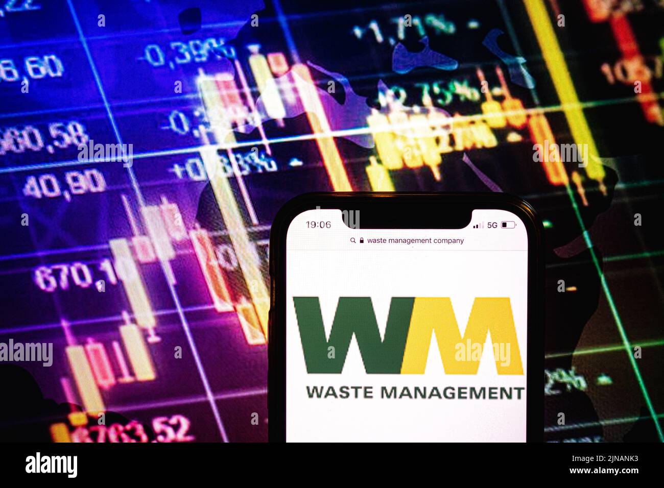 KONSKIE, POLAND - August 09, 2022: Smartphone displaying logo of Waste Management company on stock exchange diagram background Stock Photo
