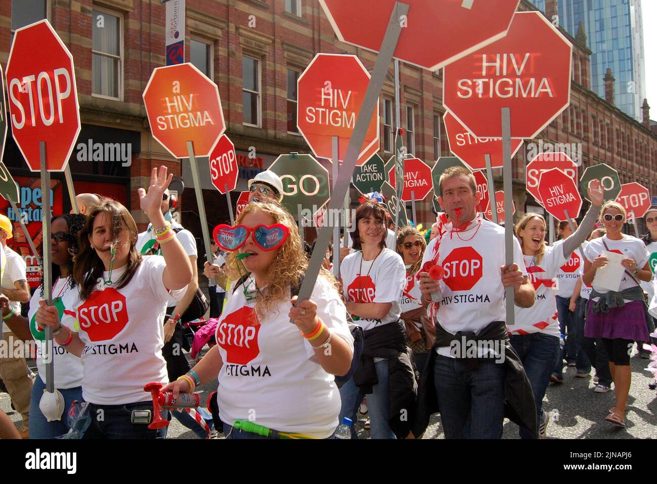 A walking float of people from the George House Trust carrying 'Stop HIV Stigma' placards and wearing t shirts with the same message in Manchester, UK, taking part in the LGBT Pride Parade on August 29, 2009. George House Trust provides services to people living with, and affected by, HIV. Stock Photo