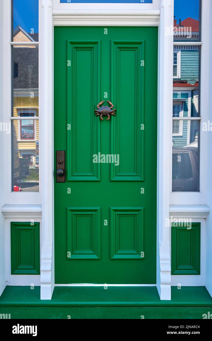 Antique green door with an interesting crab shaped door knocker on a hertitage building in Lunenburg Nova Scotia. Stock Photo