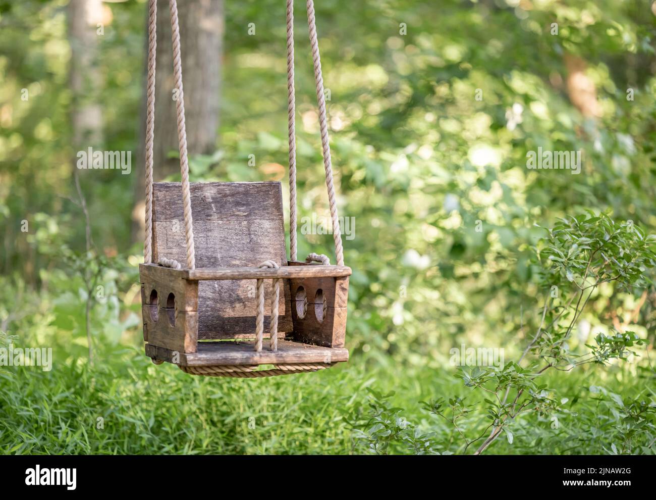 Old Wooden and rope chair swing Stock Photo
