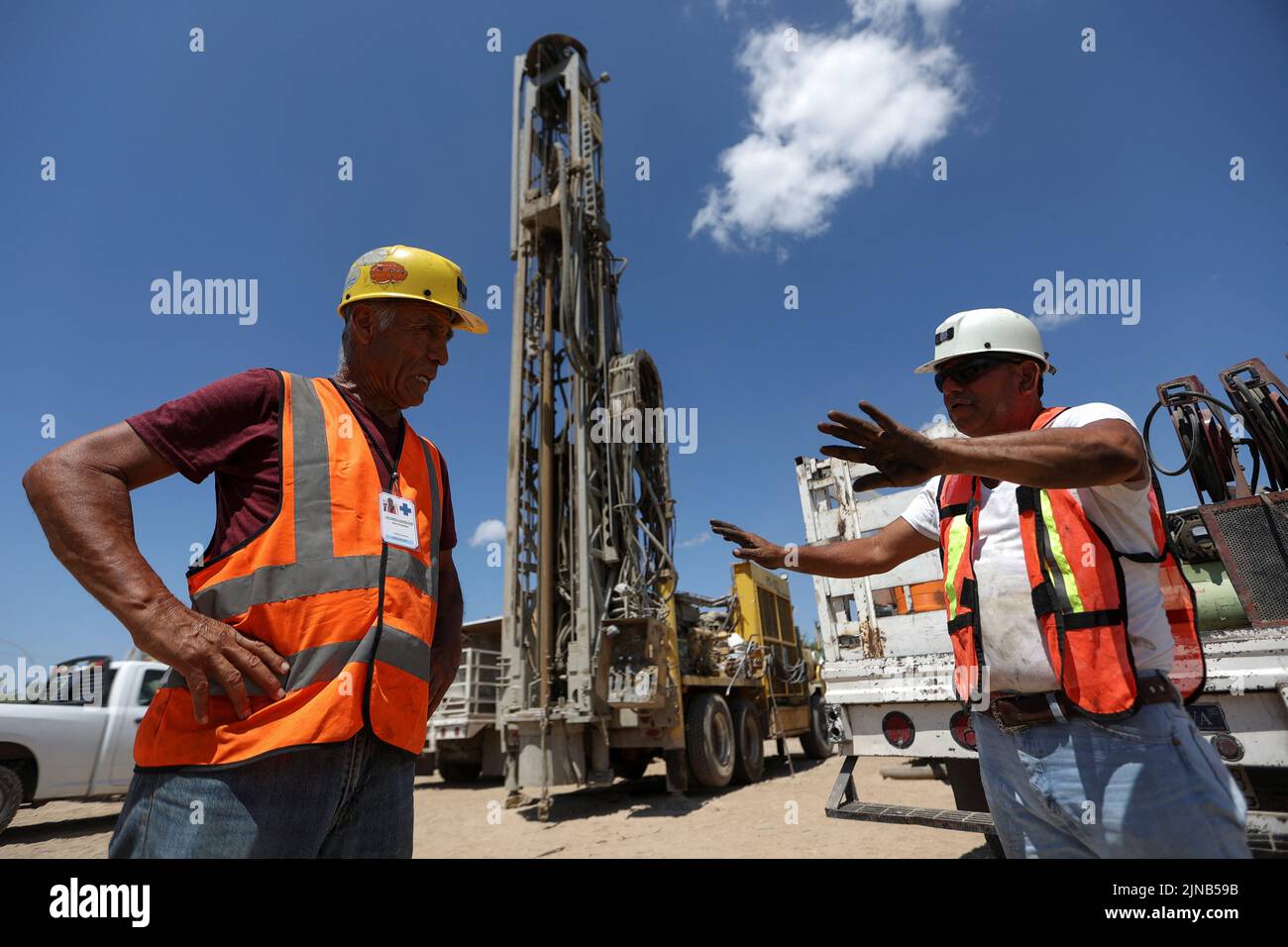 Workers talk as they participate in the rescue operation for miners trapped in a coal mine that collapsed in Sabinas, in Coahuila state, Mexico, August 10, 2022. REUTERS/Luis Cortes Stock Photo