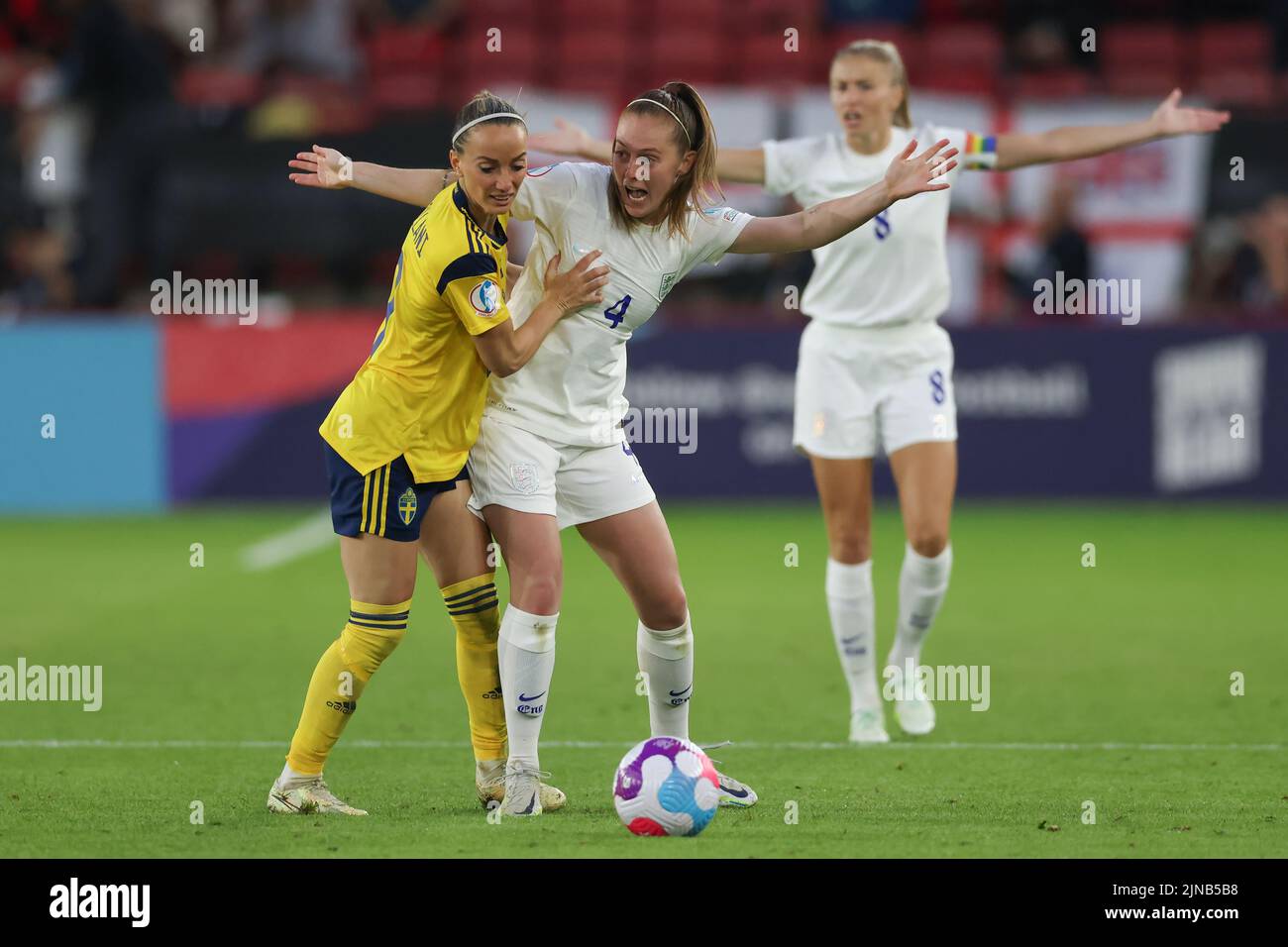 Sheffield, England, 26th July 2022. Leah Williamson of England reacts in the background as Kosovare Asllani of Sweden tussles with Keira Walsh of England  during the UEFA Women's European Championship 2022 match at Bramall Lane, Sheffield. Picture credit should read: Jonathan Moscrop / Sportimage Stock Photo