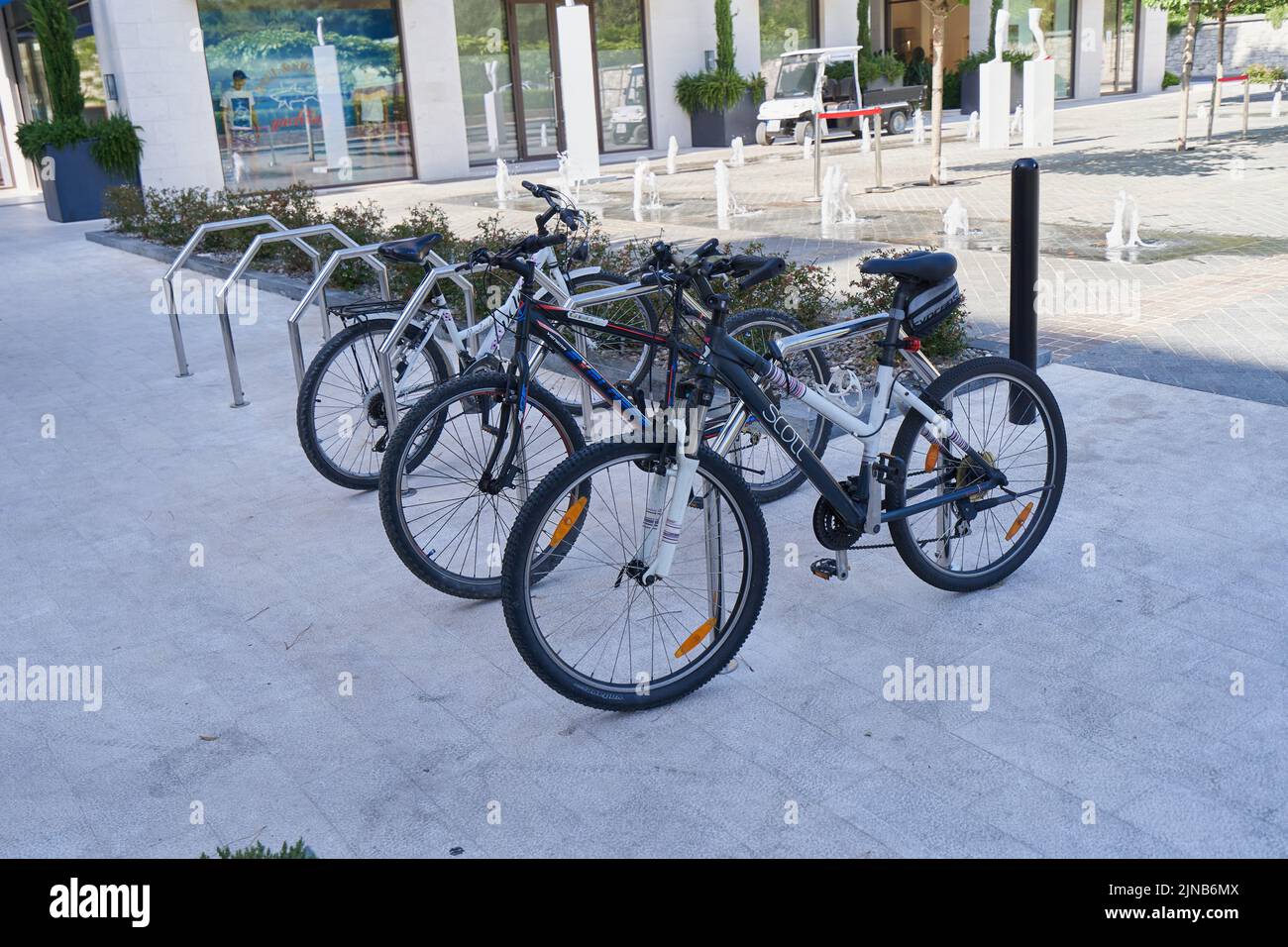 Parked bikes in a special parking area. Stock Photo