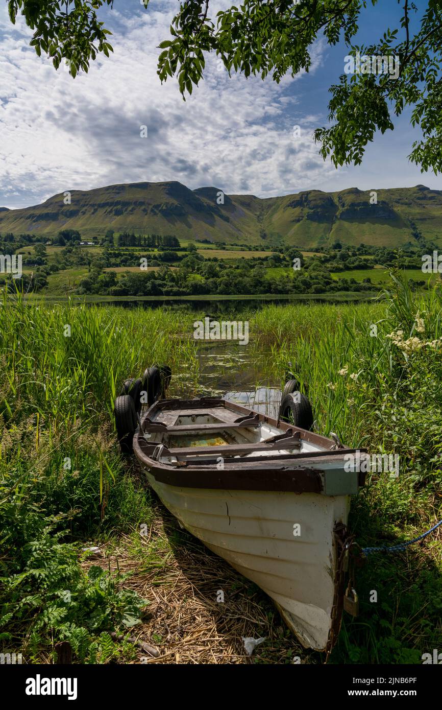 View of an old wooden fishing boat on the shores of Glencar Lough Stock ...
