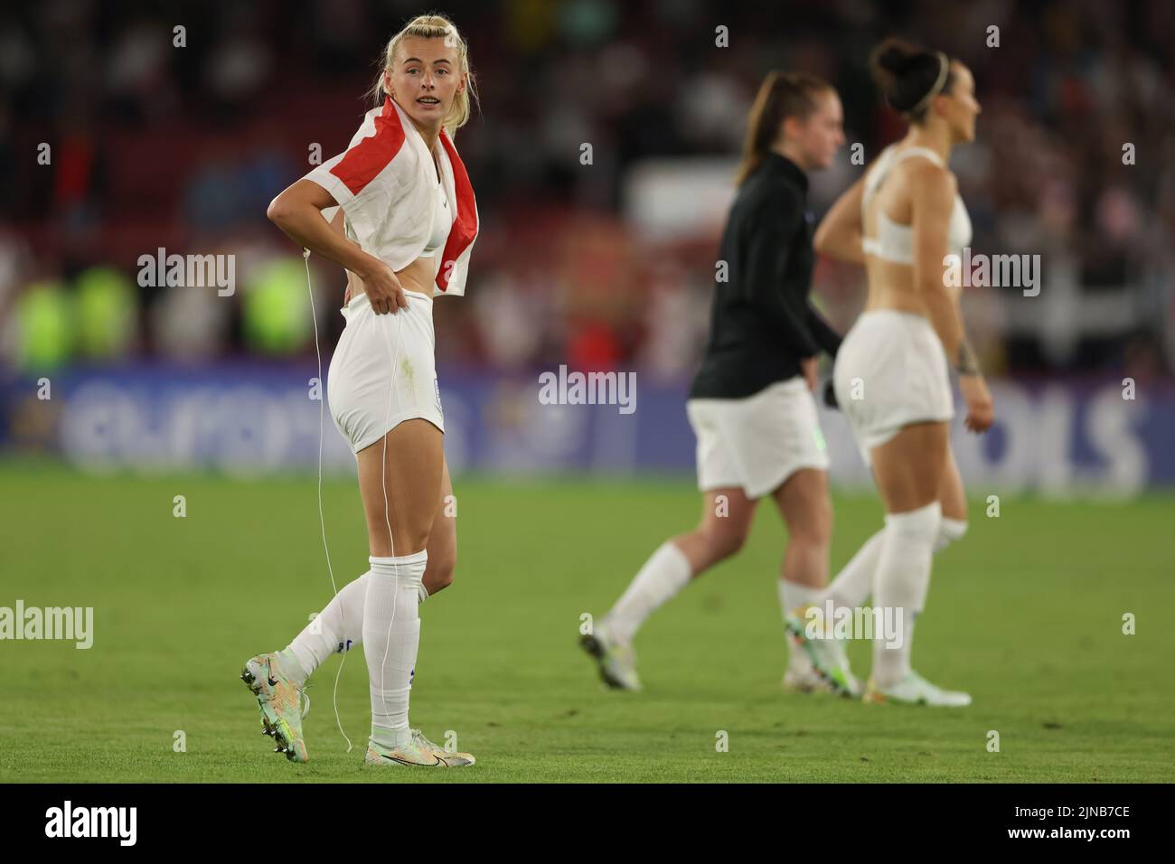 Sheffield, England, 26th July 2022. A shirtless Chloe Kelly of England looks on wearing her sports bras and a St. Goerge's cross flag over her shoulders following the final whistle of the UEFA Women's European Championship 2022 match at Bramall Lane, Sheffield. Picture credit should read: Jonathan Moscrop / Sportimage Stock Photo
