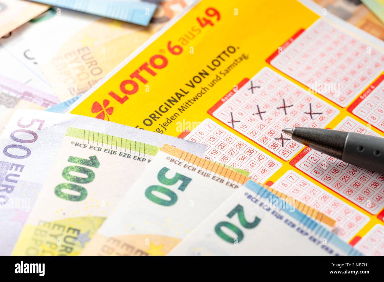 A Lotto 6 Out Of 24 Winning Ticket On Many Different Euro Banknotes, Symbol Image Play Lotto And Win. Lotto Ticket Stock Photo