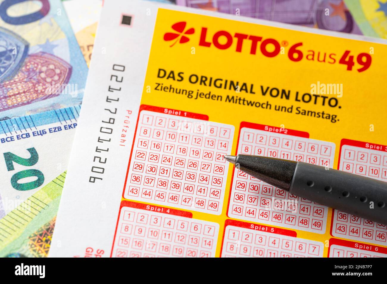A Lotto 6 Out Of 49 Winning Ticket On Many Different Euro Banknotes, Symbol Image Play Lotto And Win. Lotto Ticket Stock Photo