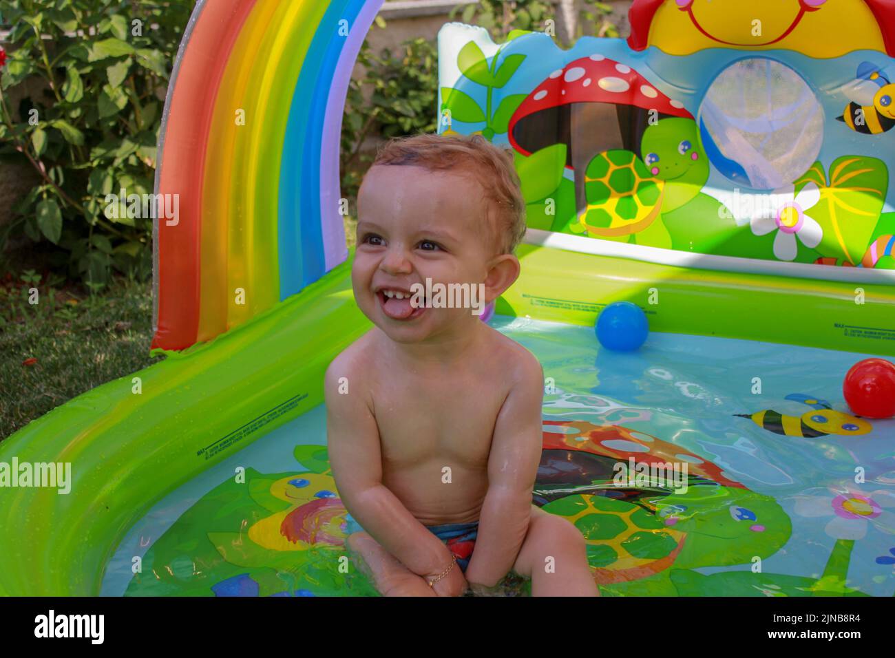 the joy of my one year old son while having a bath in the sun Stock Photo Alamy