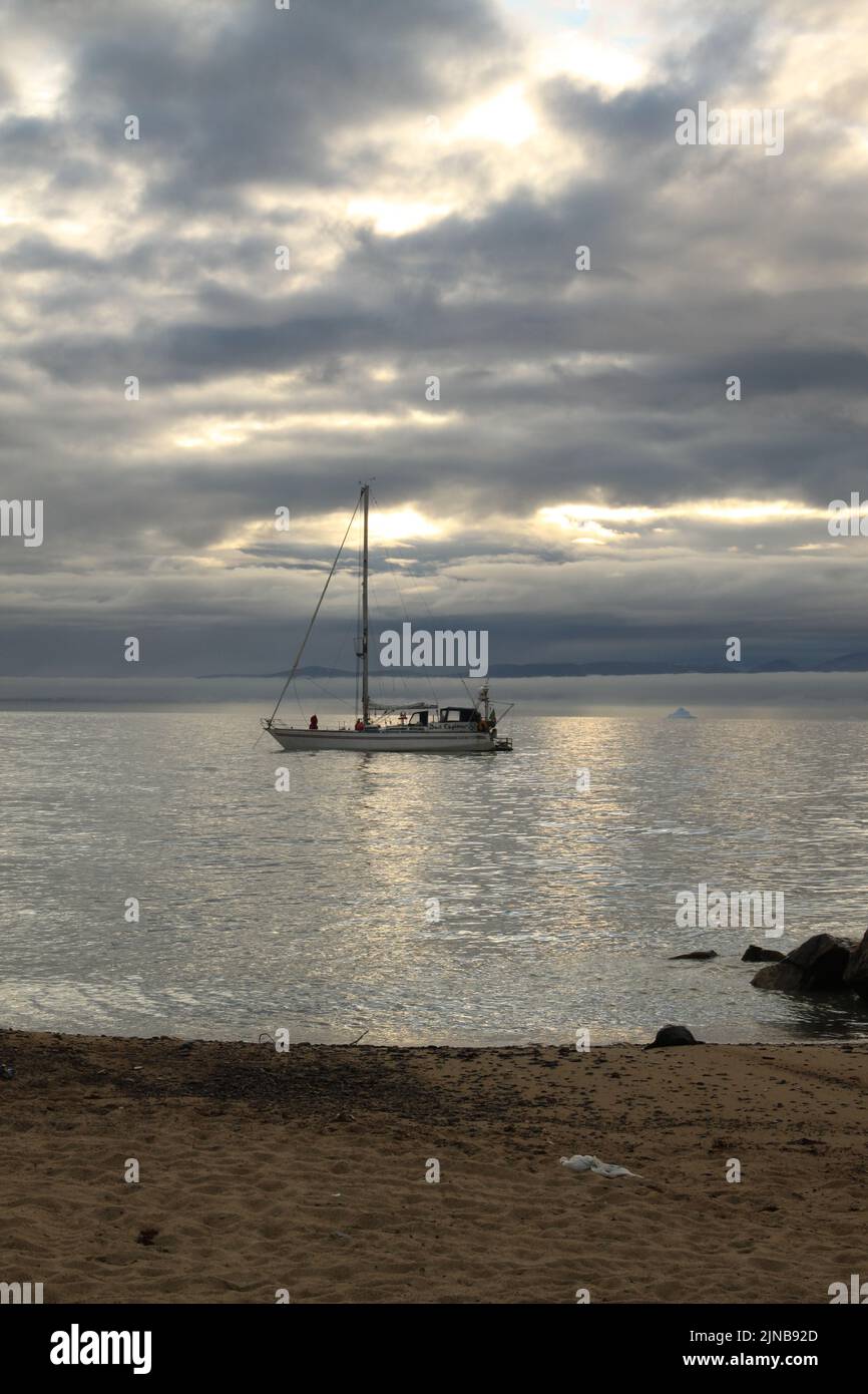 A sailboat anchored near Pond Inlet, Nunavut waiting for weather to
