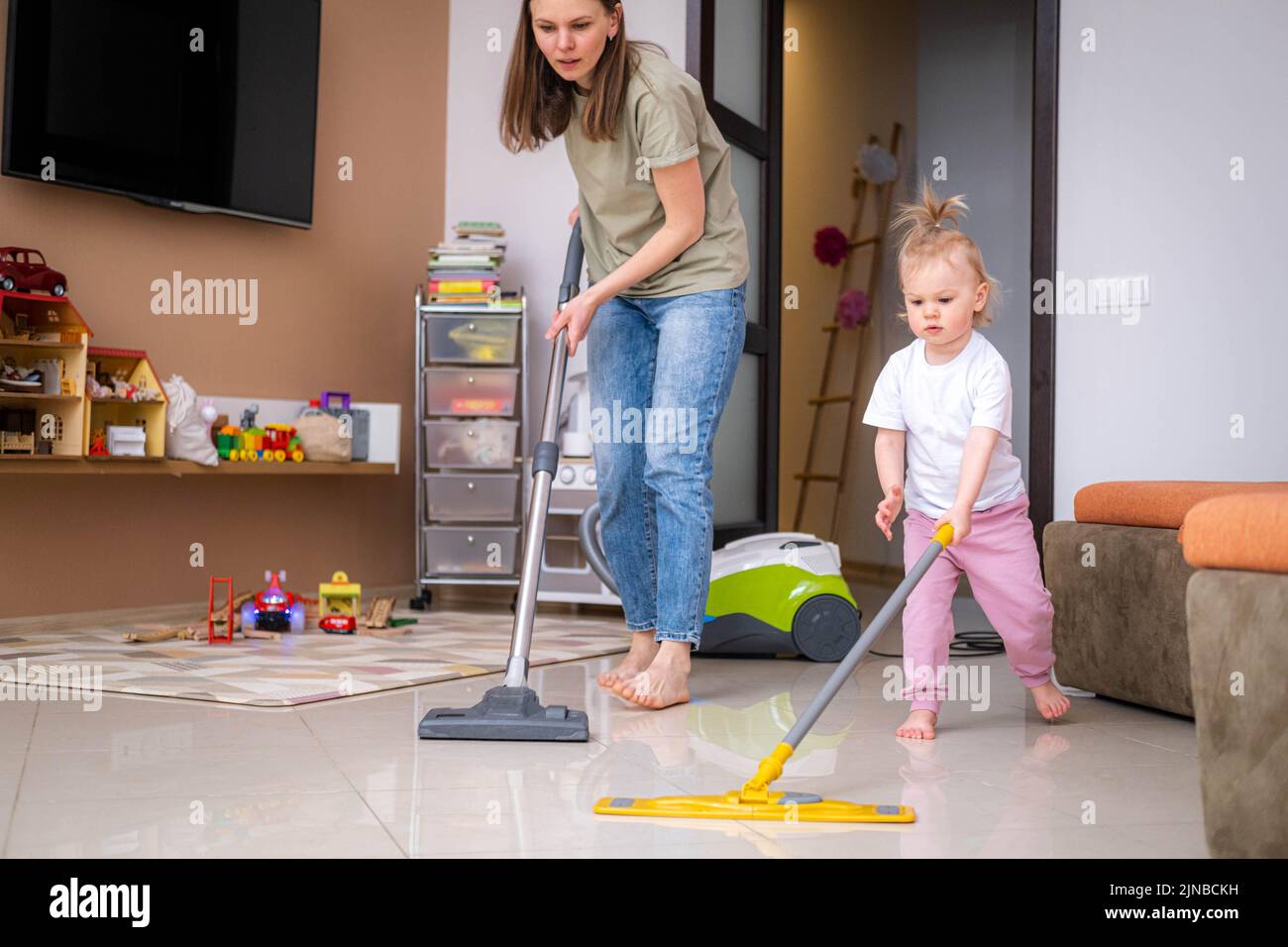 little daughter cleaning in the house, child dusting, Cute little ...
