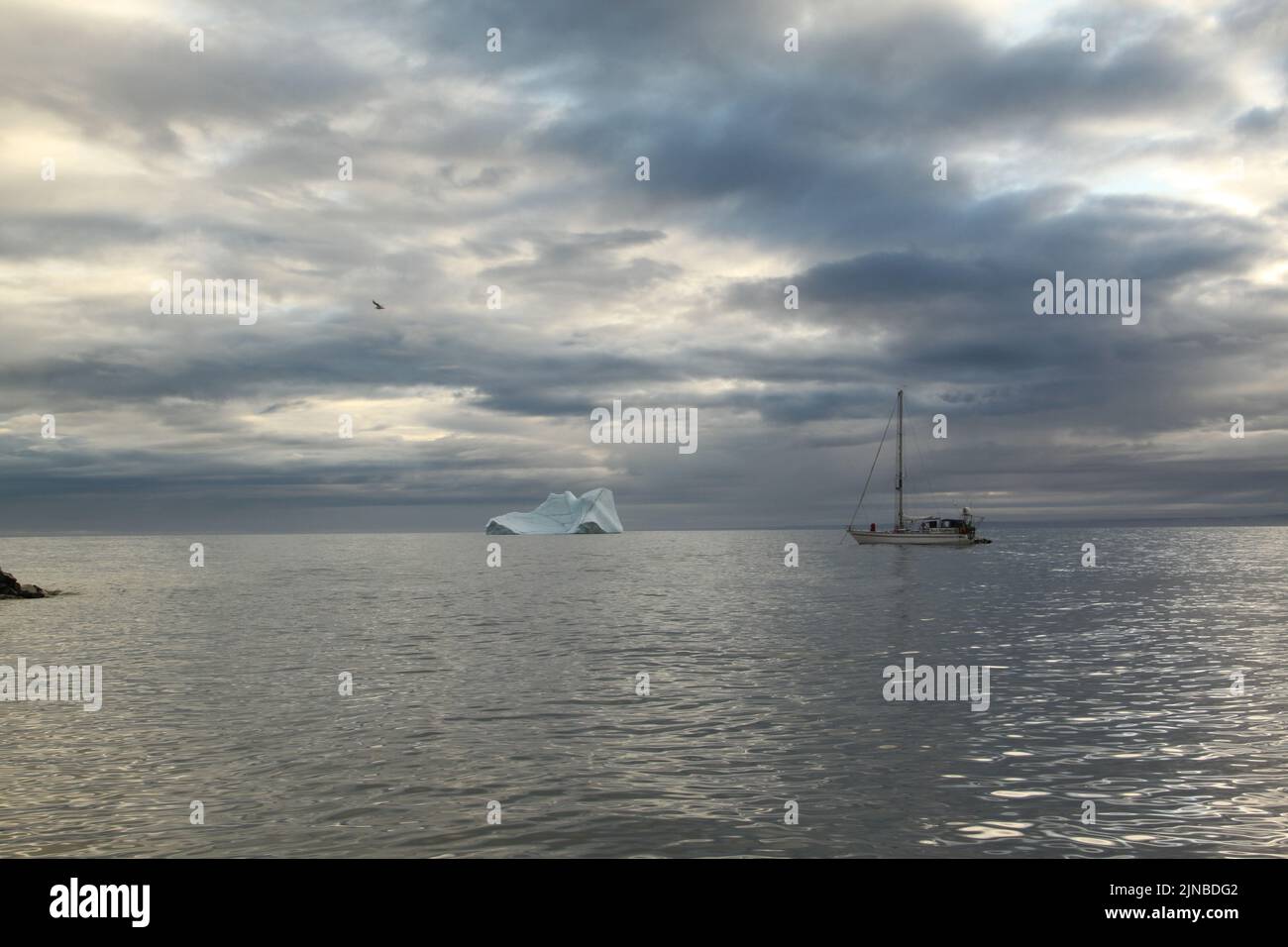 A sailboat anchored near Pond Inlet, Nunavut waiting for weather to transit through the Northwest Passage, Canada Stock Photo
