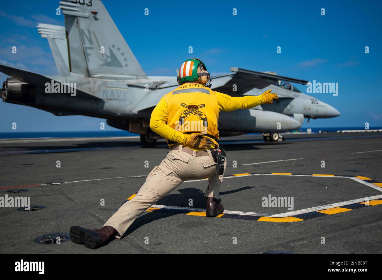 Pacific Ocean, United States. 09th Aug, 2022. U.S. Navy Shooter Lt. TJ Whiting launches an F/A-18E Super Hornet fighter aircraft attached to the Eagles of Strike Fighter Squadron 115, on the flight deck of the Nimitz-class aircraft carrier USS Ronald Reagan underway, August 9, 2022 in the Philippine Sea. Credit: MC3 Gray Gibson/Planetpix/Alamy Live News Credit: Planetpix/Alamy Live News Stock Photo