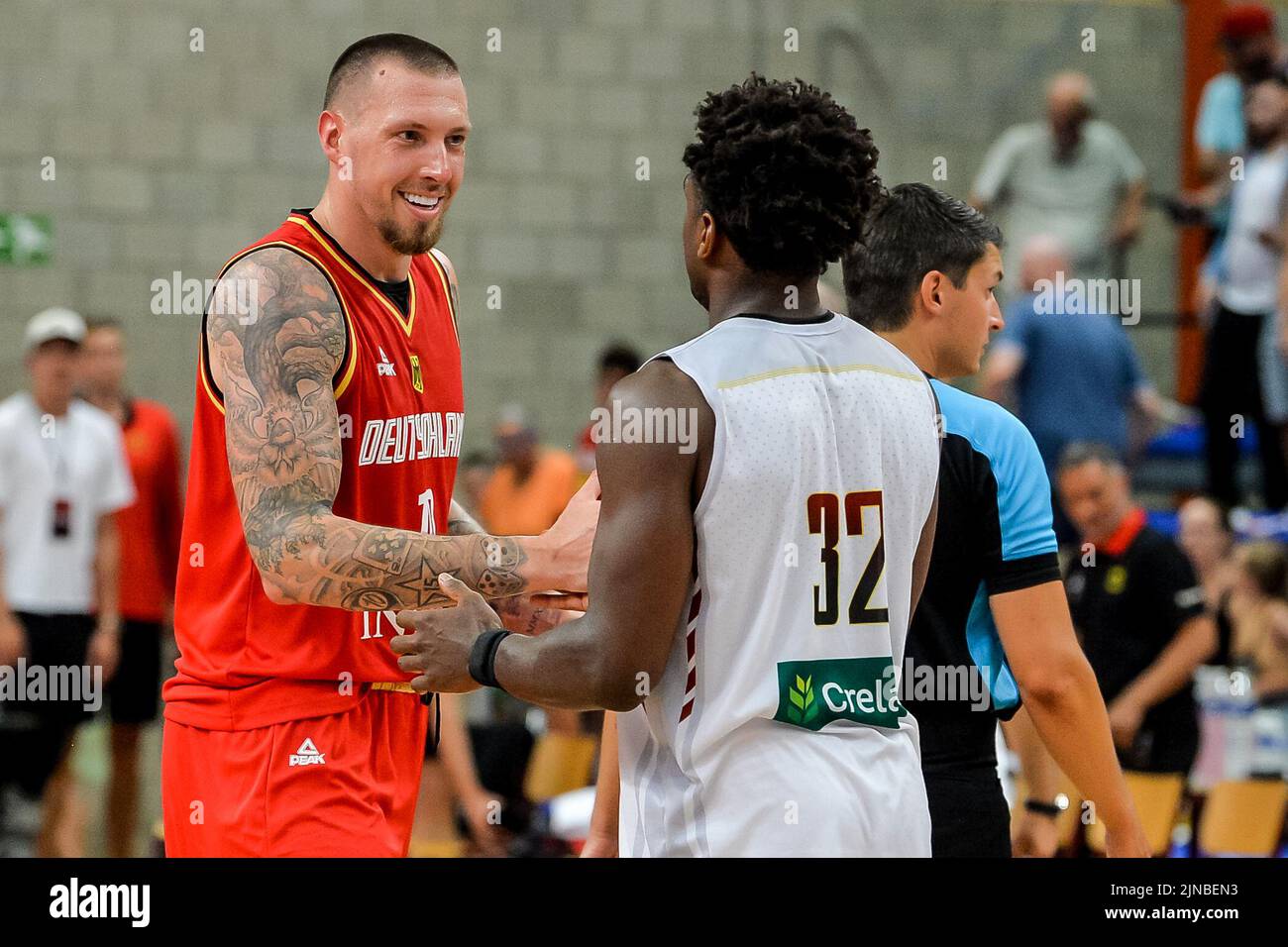 Germany's Daniel Theis (10) and Belgium's Retin Obasohan (32) pictured after a friendly basketball match ahead of the European Championships between Belgian national team 'the Belgian Lions' and Germany, Wednesday 10 August 2022, in Hasselt. BELGA PHOTO JILL DELSAUX Stock Photo