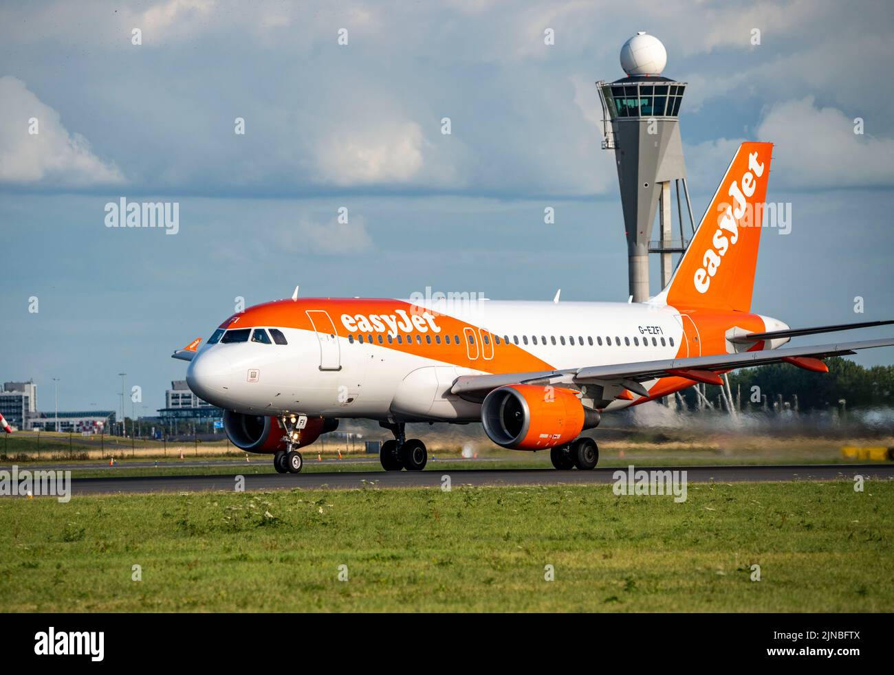 Amsterdam Shiphol Airport, Polderbaan, one of 6 runways, tower air traffic control, G-EZFI easyJet Airbus A319-100, Stock Photo