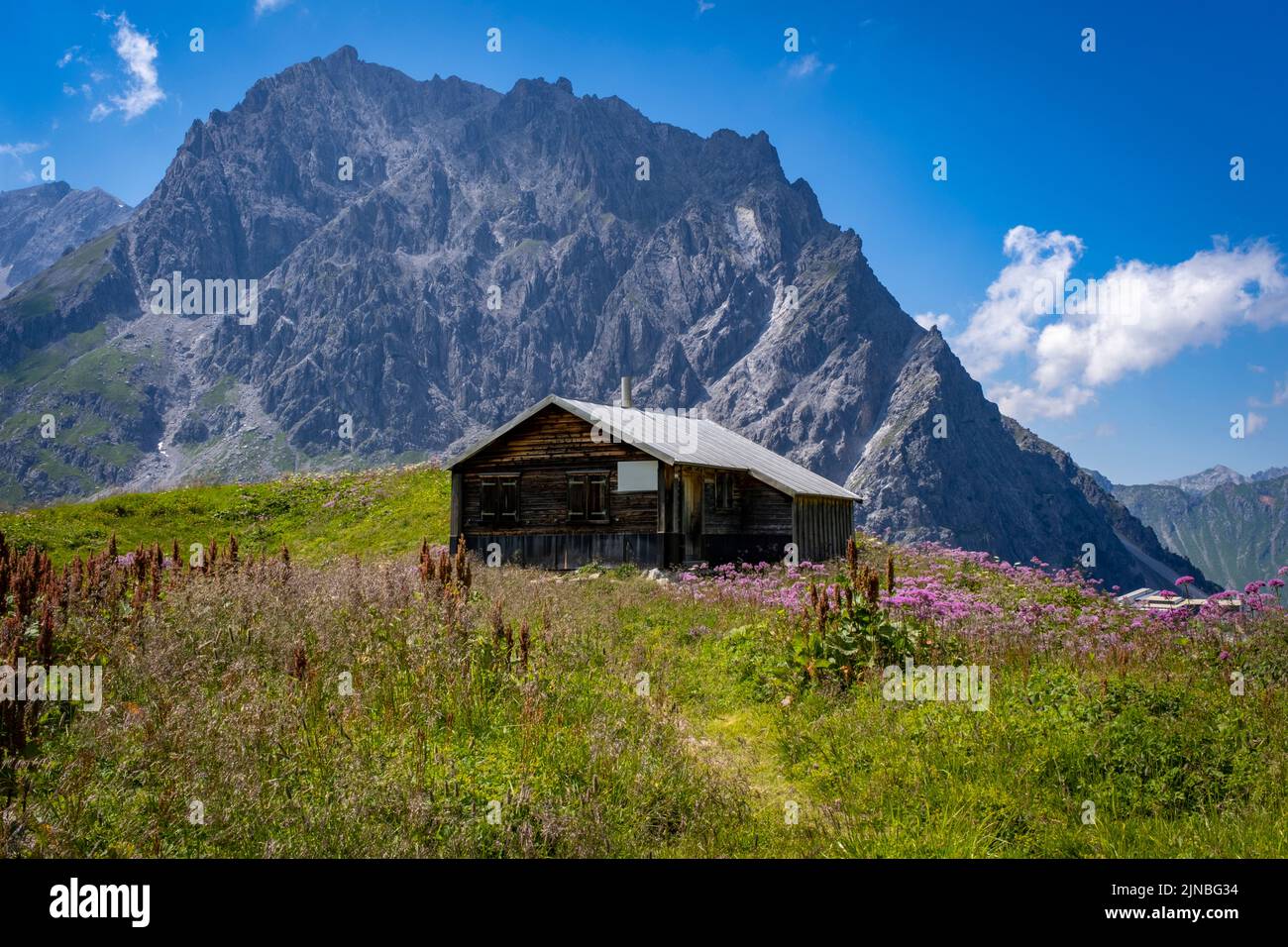 relaxing on a bench and lodge at the Luenersee in Vorarlberg, Austria Stock Photo