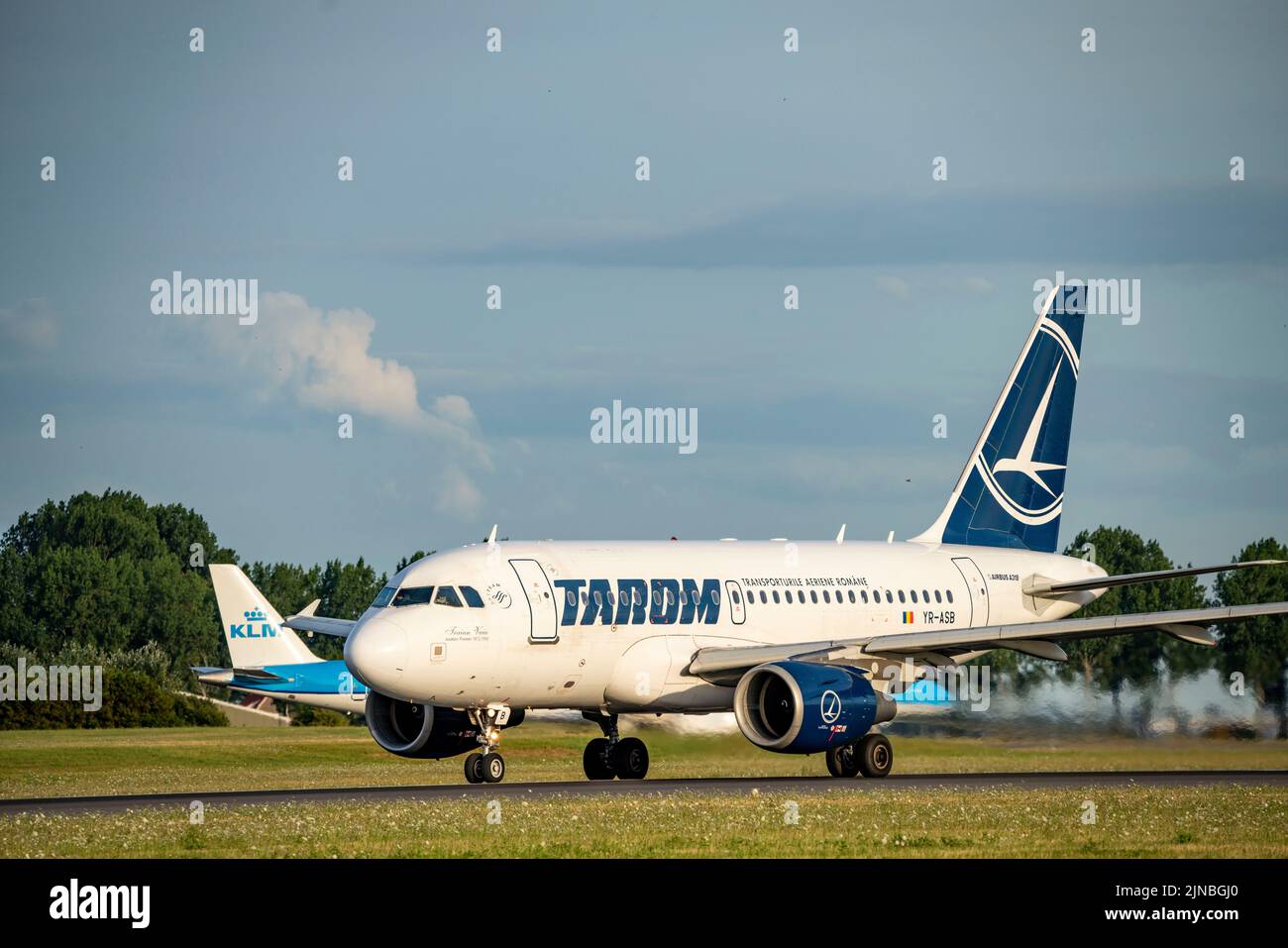 Amsterdam Shiphol Airport, Polderbaan, one of 6 runways, on taxiway for take-off, YR-ASB, TAROM Airbus A318-100. Stock Photo