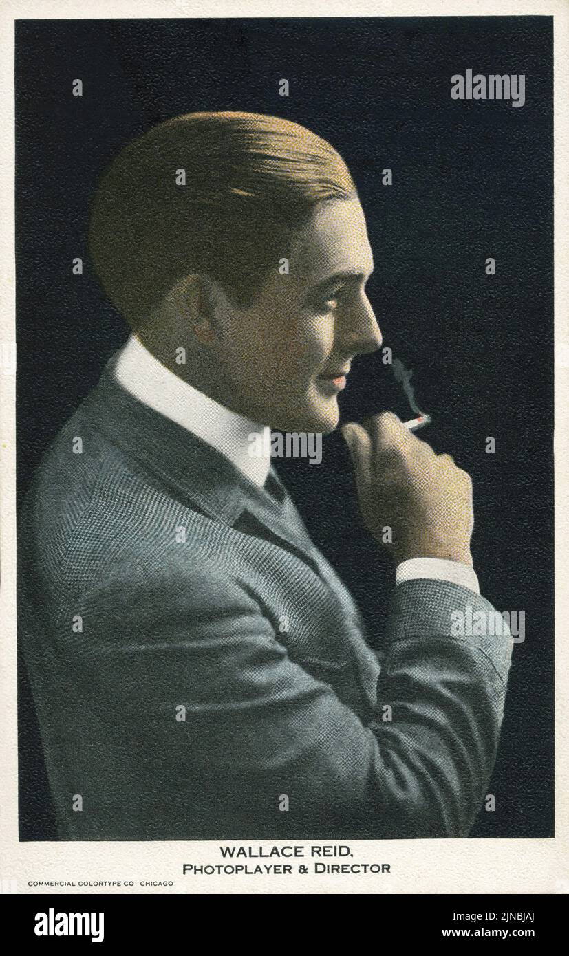 Vintage colorized portrait of actor and director Wallace Reid in profile smoking a cigarette circa 1920s Stock Photo