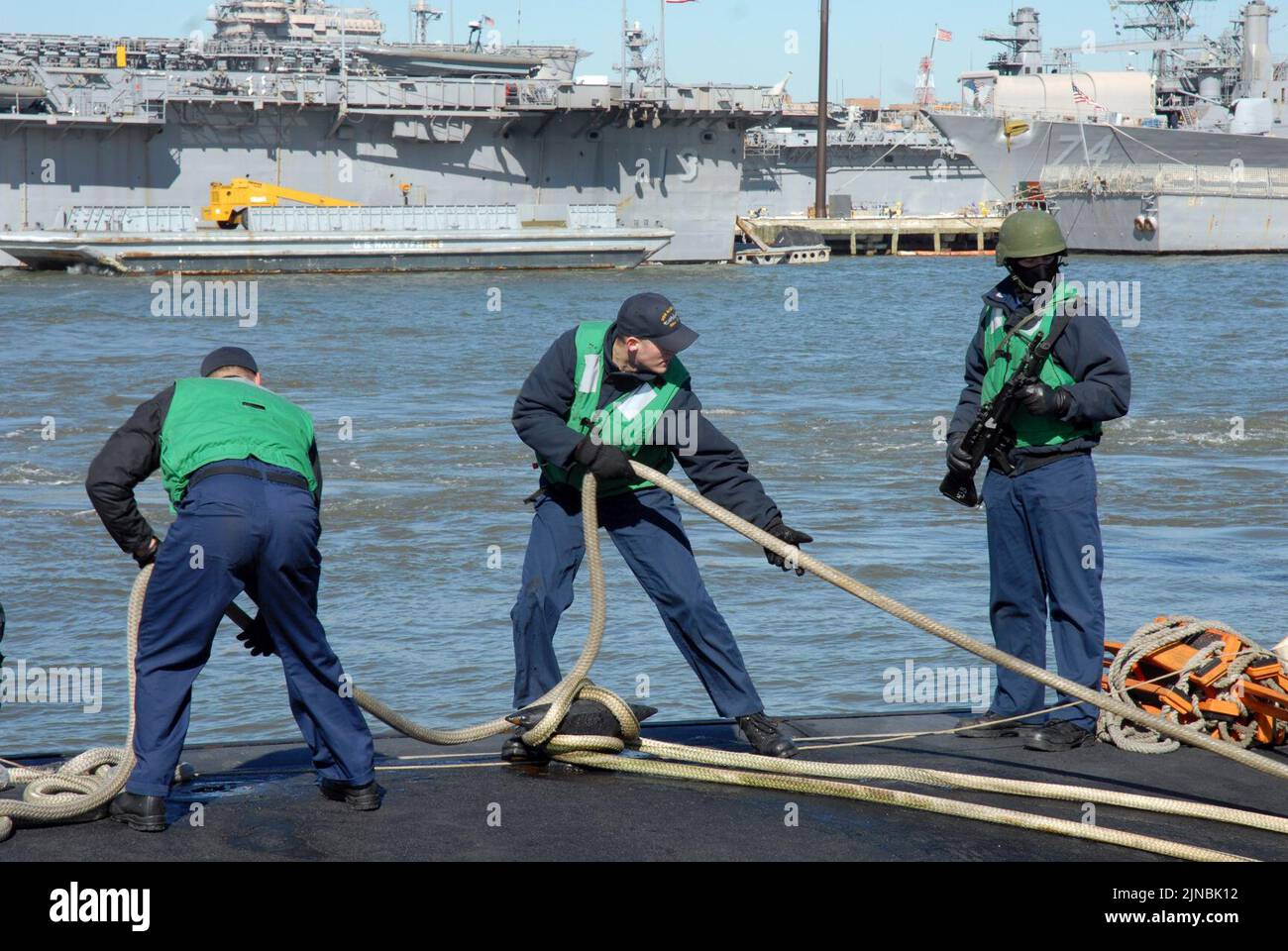 Tending to mooring lines at Naval Station Norfolk Stock Photo