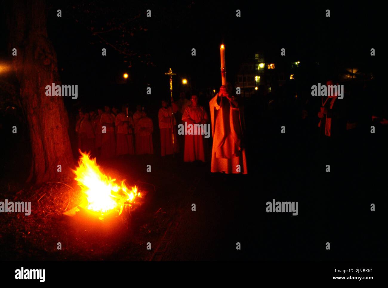 Priest Holding Paschal Candle High Walking by the Easter Fire on Holy Saturday Easter Vigil St Joseph's Catholic Church Roehampton London England Stock Photo