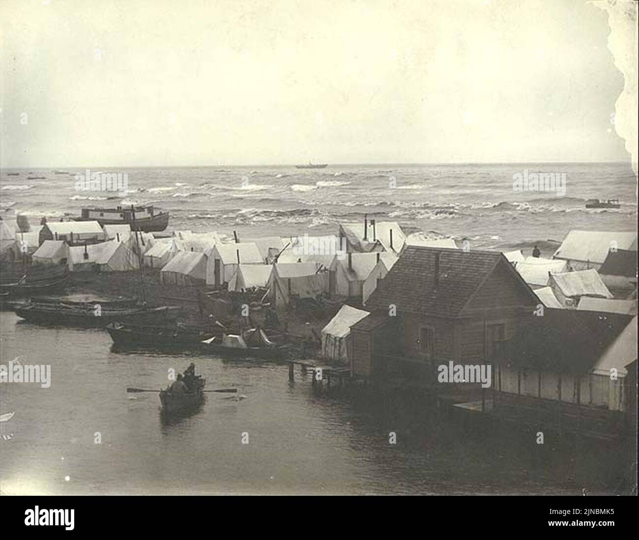 Tents and houses on sand spit separating the Snake River with the