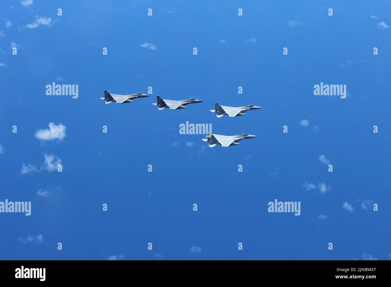 East China Sea, Japan. 10 August, 2022. U.S. Air Force F-15C and Japanese Air Self-defense Force F-15J fighter jets with the 9th Air Wing, fly in formation during bilateral training to enhance deterrence and response capabilities in the Indo-Pacific region, August 4, 2022 off the coast of Okinawa, Japan.  Credit: JASDF/U.S. Air Force/Alamy Live News Stock Photo