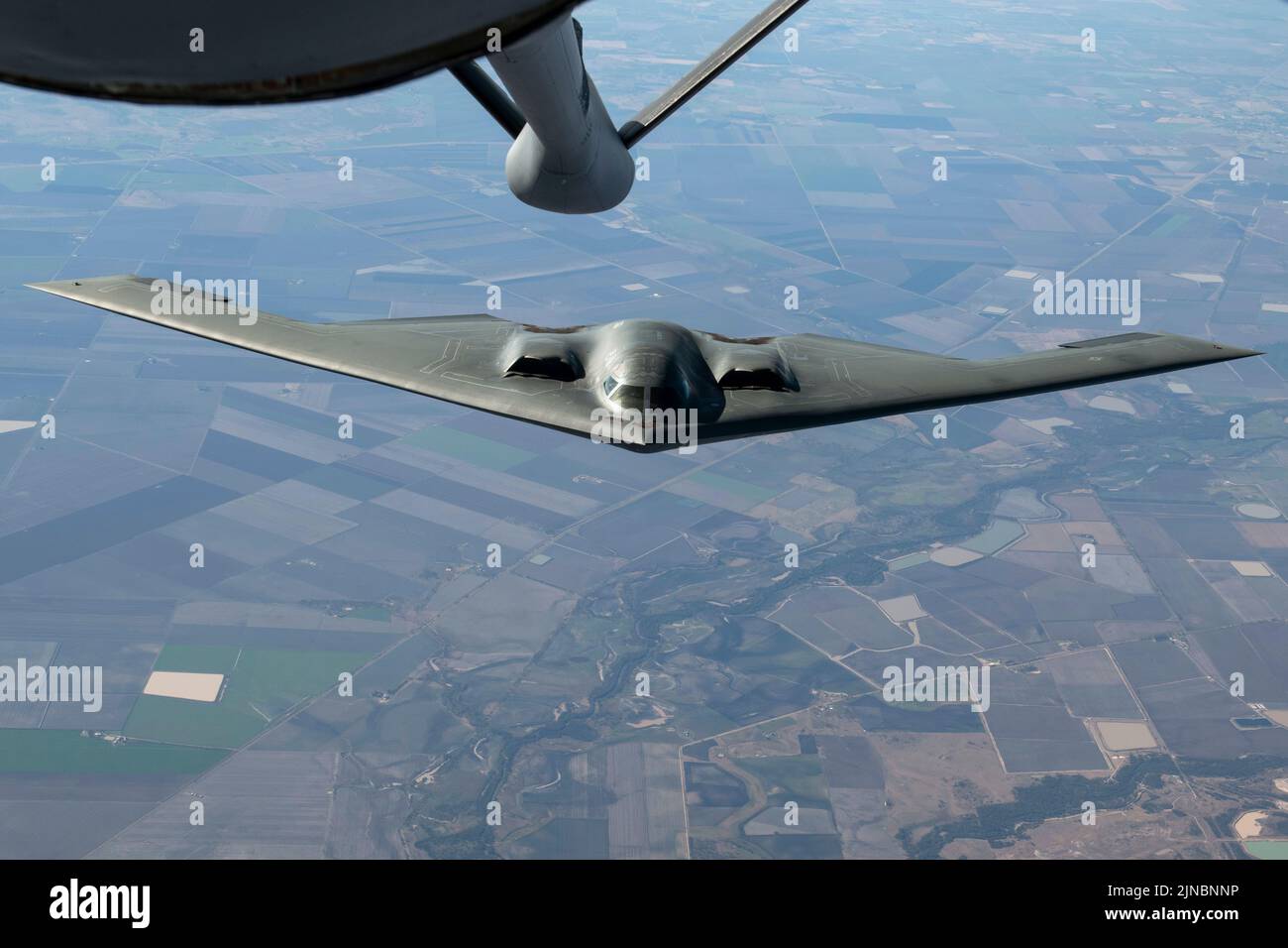 Amberley, Australia. 18 July, 2022. U.S. Air Force B-2 Spirit stealth strategic bombers, with the 509th Bomb Wing, approaches a KC-135 tanker to refuel escorted by Royal Australian Air Force fighter aircraft during exercise Koolendong 22, July 18, 2022 over Australia.  Credit: TSgt. Dylan Nuckolls/US Air Force/Alamy Live News Stock Photo