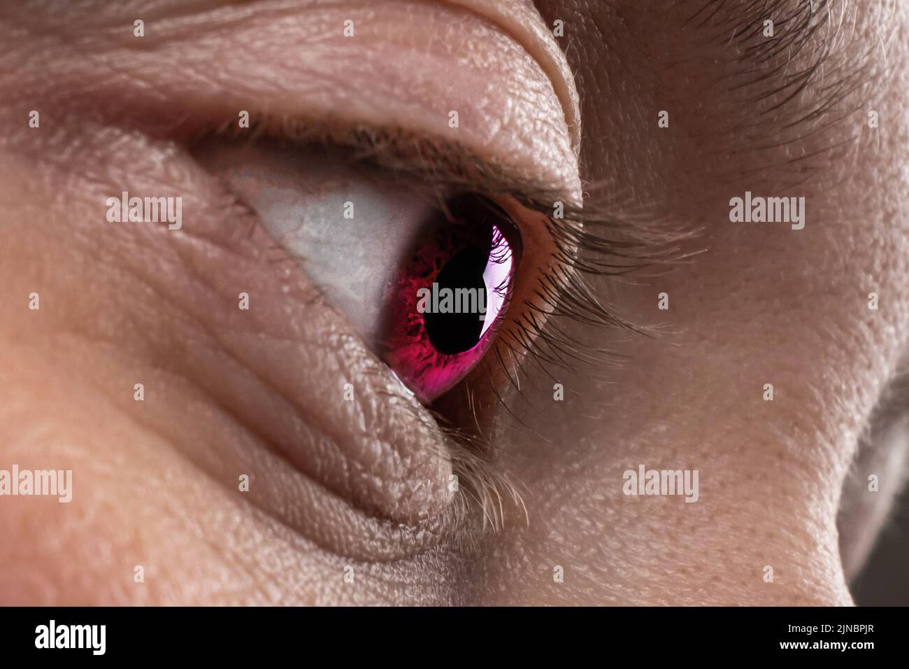 human fantastic red eye closeup, female look. Stock Photo