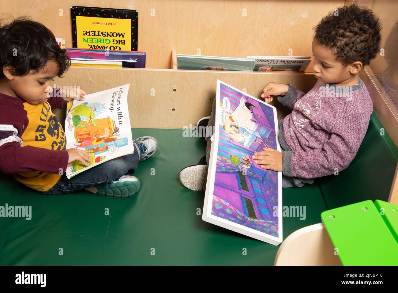 Education Preschool Child Care 4 year olds two boys looking at picture books Stock Photo