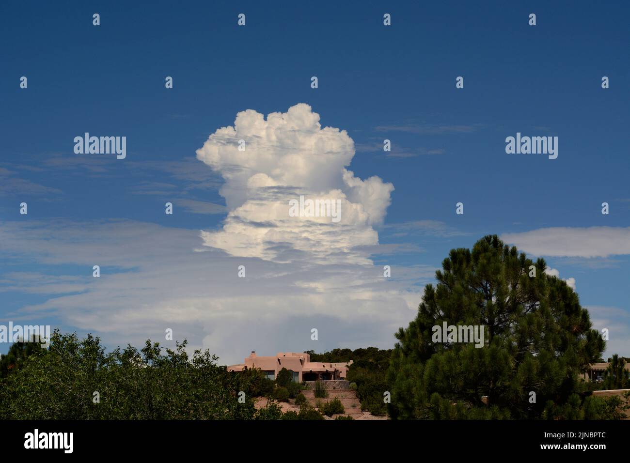 Towering cumulus clouds form on the horizon near Santa Fe, New Mexico. Stock Photo