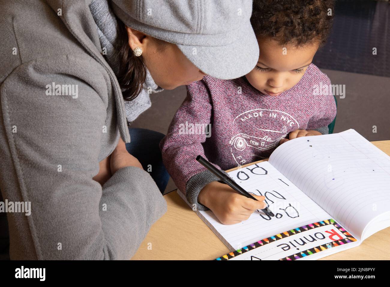 Education Preschool Child Care start of day sigh in routine, parent looking on Stock Photo