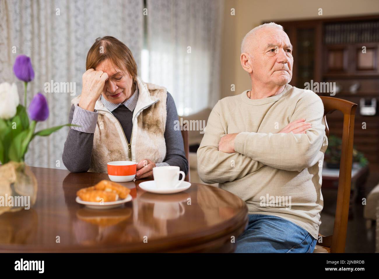 Senior couple after quarrel in living room Stock Photo
