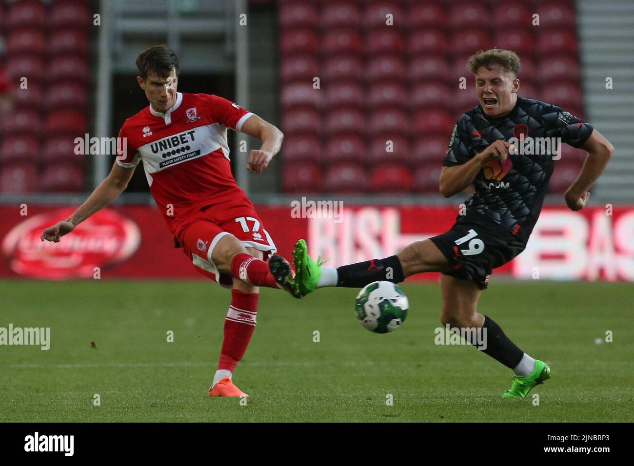 Middlesbrough, UK. 10th August, 2022. Middlesbrough's Paddy McNair plays a forward pass as Barnsley's Aiden Marsh lunges in for a tackle during the Carabao Cup match between Middlesbrough and Barnsley at the Riverside Stadium, Middlesbrough on Wednesday 10th August 2022. (Credit: Michael Driver | MI News) Credit: MI News & Sport /Alamy Live News Stock Photo