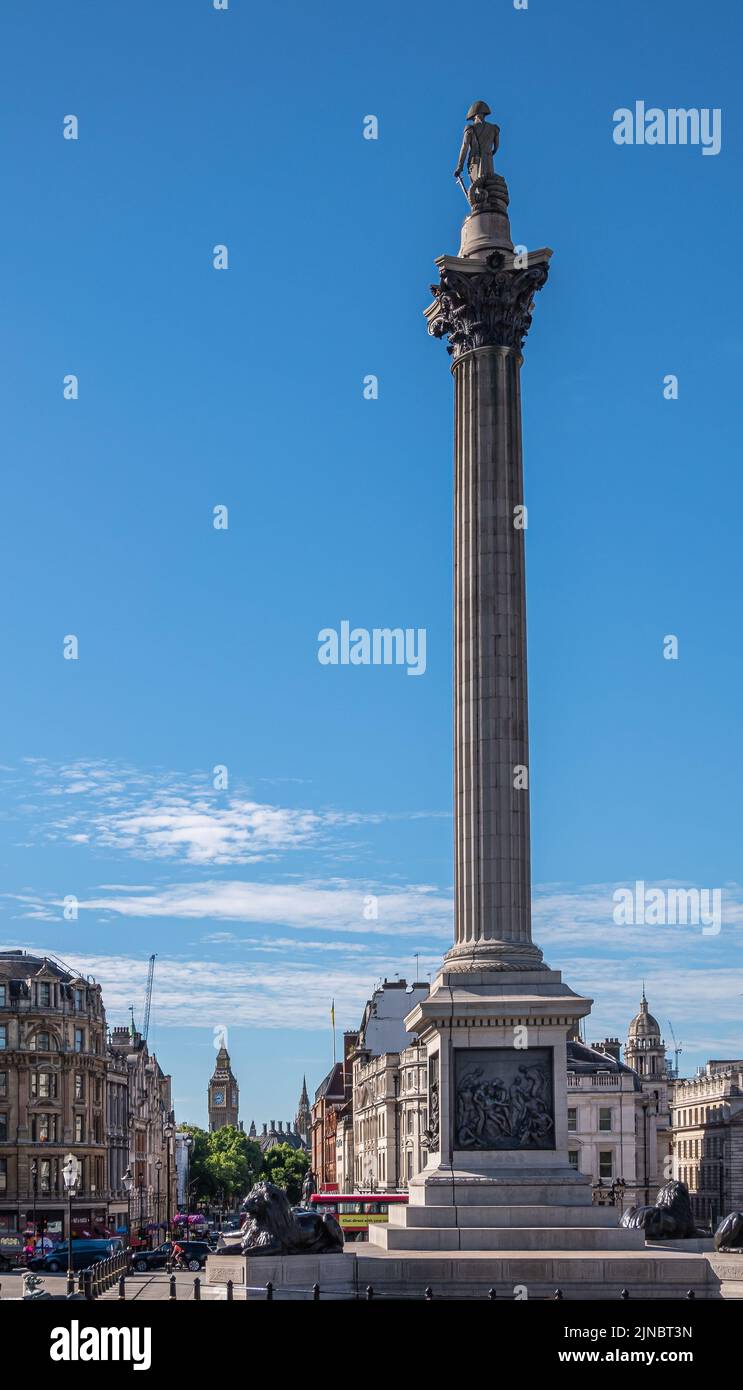 London, UK- July 4, 2022: Trafalgar Square. Nelson's Column in front all the way to Big Ben tower under blue sky. Buildings and traffic in between. Stock Photo