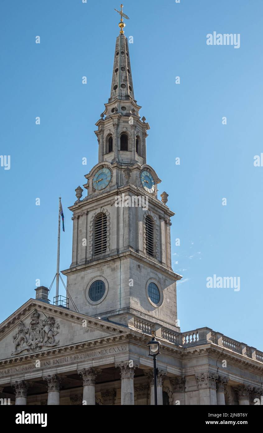 London, UK- July 4, 2022: Trafalgar Square. Spire,, clock Tower and pediment of St. Martin-in-the-fields church against blue sky. Stock Photo