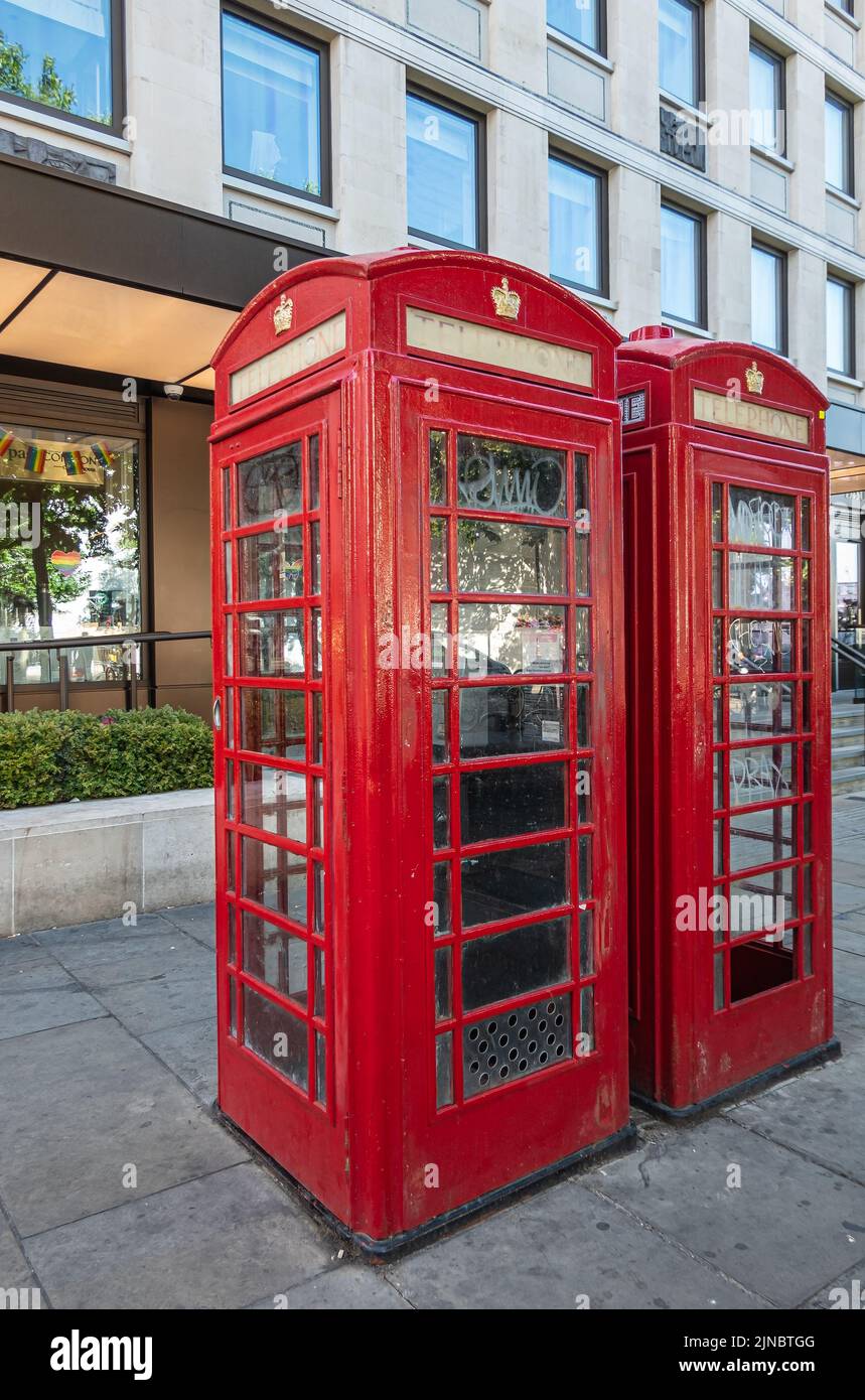 London, UK- July 4, 2022: Trafalgar Square. Closeup of 2 red telephone boots still in operation Stock Photo