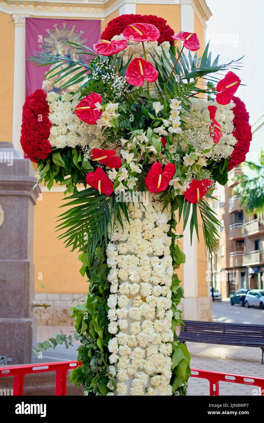 Detail of a Cruz de Mayo in Valencia. This type of crosses made with flowers are usually placed at the beginning of the month of May in the streets an Stock Photo