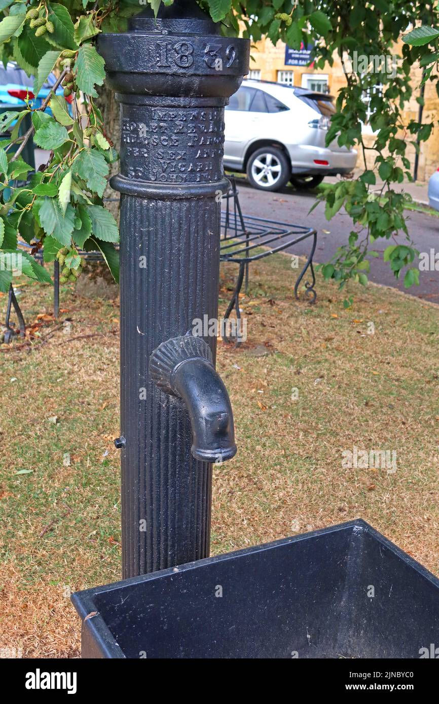 1832 black cast iron well pump, Chipping Camden, Cotswolds market town, Cotswold, Oxfordshire, England, UK, GL55 6AA Stock Photo