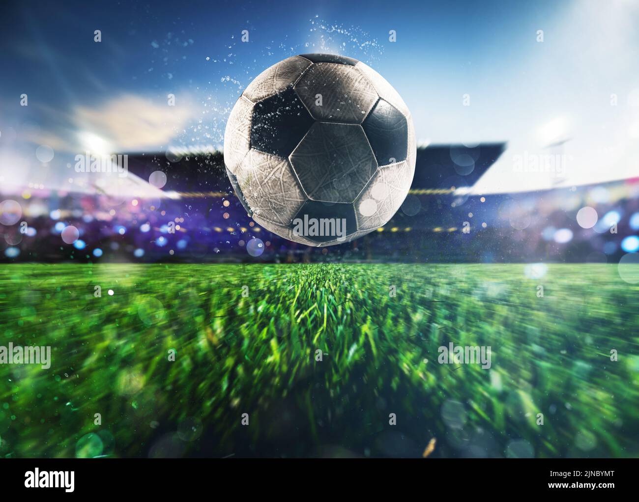 Close up of a soccer ball kicked with power at the stadium Stock Photo