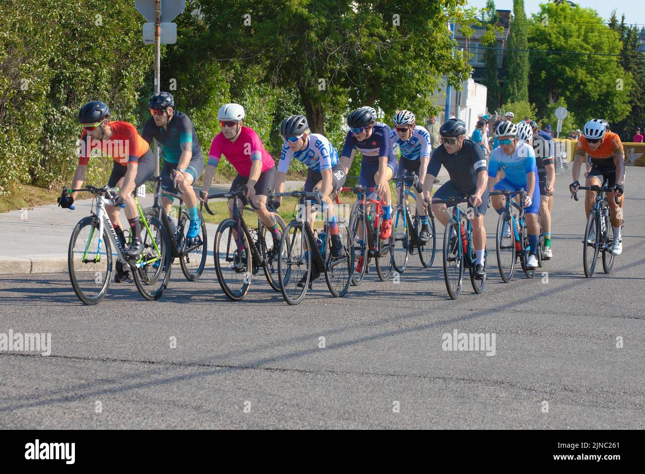 Bicycle racers in the peloton riding a lap of the Criterium, a cycling road race where the