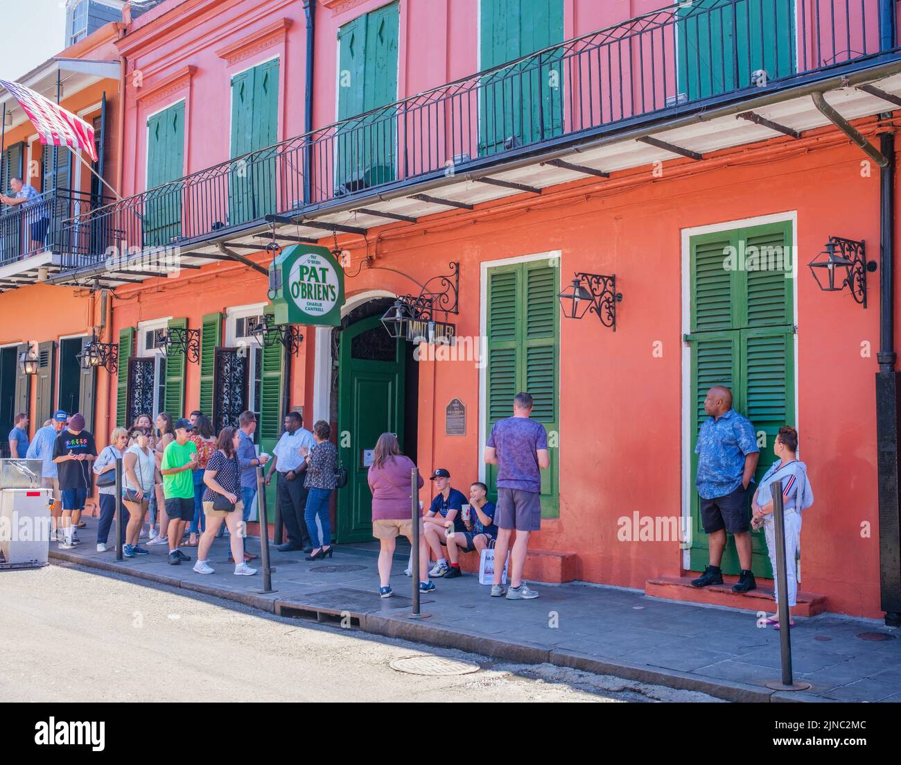 NEW ORLEANS, LA, USA - APRIL 3, 2022: People waiting in front of world famous Pat O'Brien's on St. Peter Street in the French Quarter Stock Photo