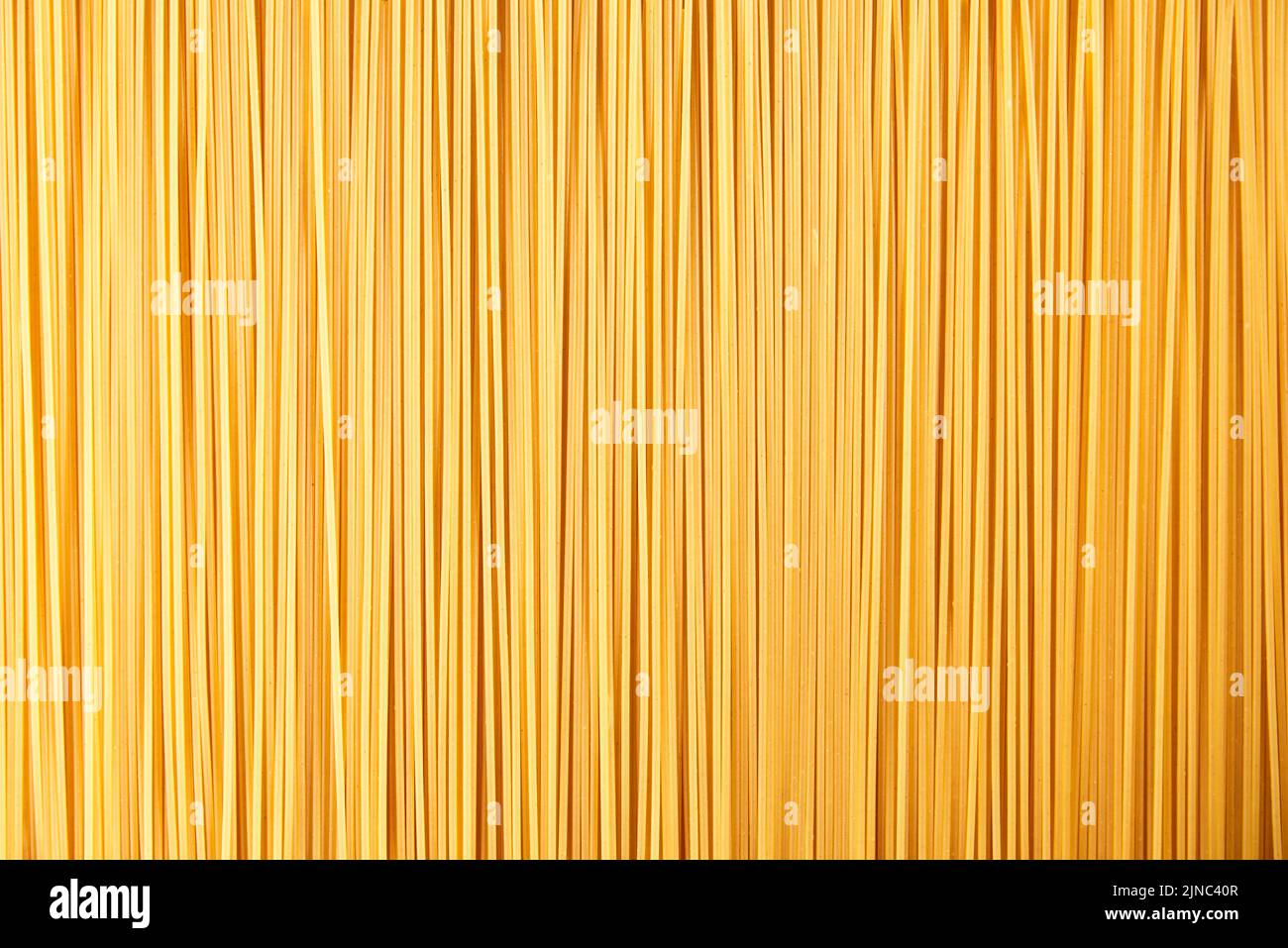 Italian food background, raw spaghetti filling the frame in a textured