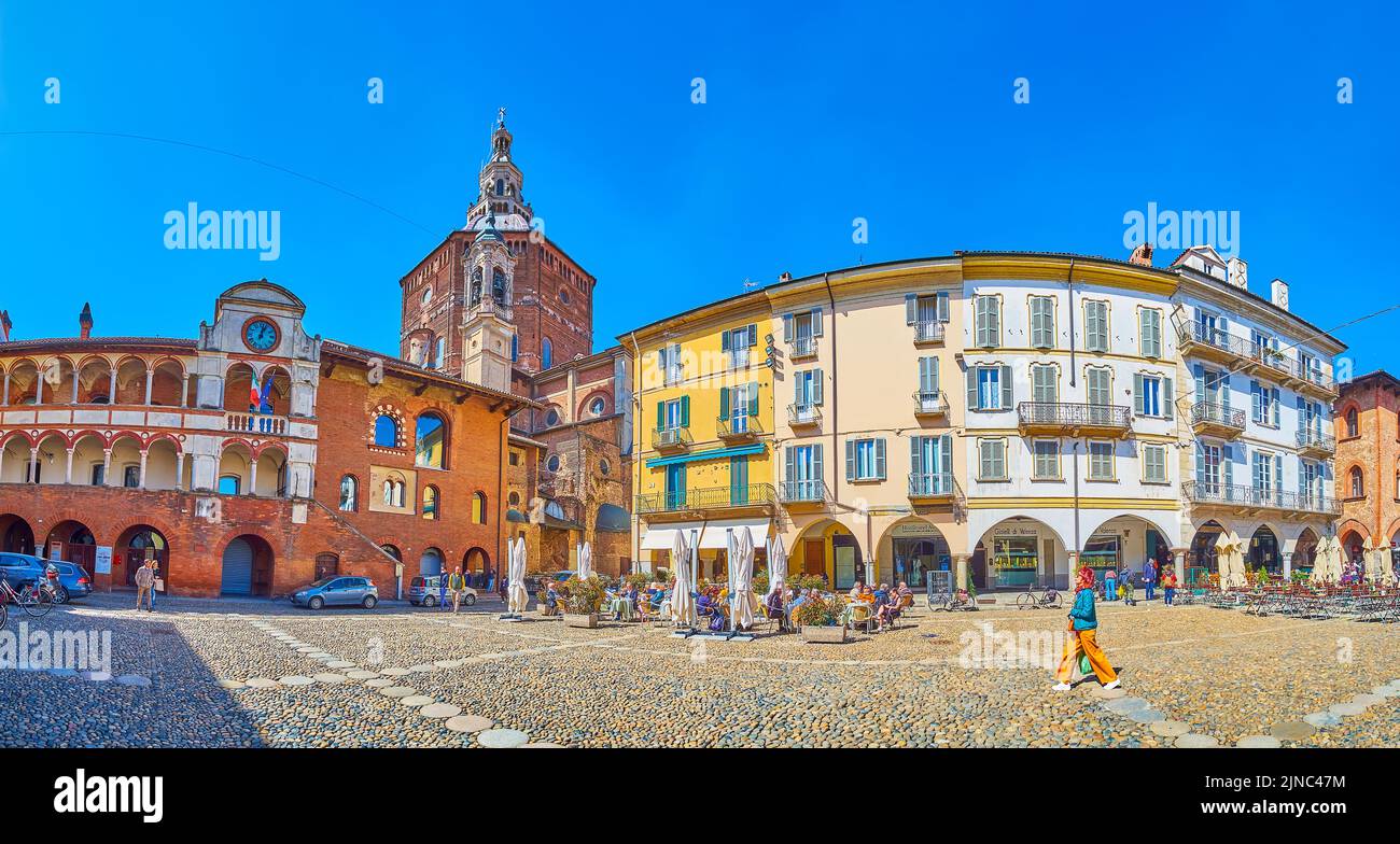 PAVIA, ITALY - APRIL 9, 2022: Panoramic view on medieval buildings of Piazza della Vittorio with high dome of Cathedral on background, on April 9 in P Stock Photo