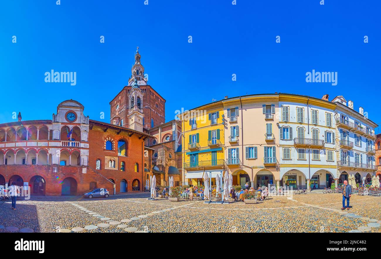 PAVIA, ITALY - APRIL 9, 2022: Panorama of Piazza Grande, the popular square in old town with outdoor restaurants and historical villas surrounding it, Stock Photo