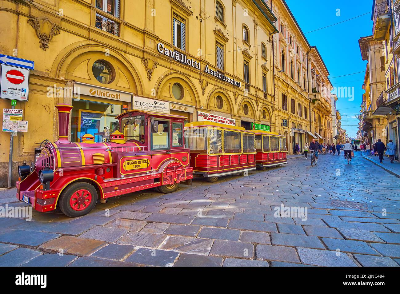 PAVIA, ITALY - APRIL 9, 2022: The tourist tram on Corso Strada Nuova street in old town, on April 9 in Pavia, Italy Stock Photo