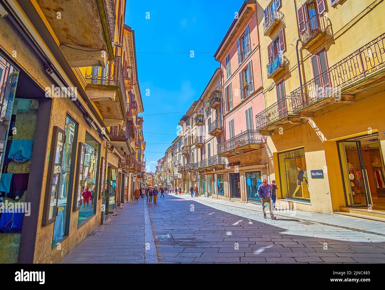 PAVIA, ITALY - APRIL 9, 2022: Walk along Corso Strada Nouva street sandwiched between historical buildings with stores and cafes, on April 9 in Pavia, Stock Photo