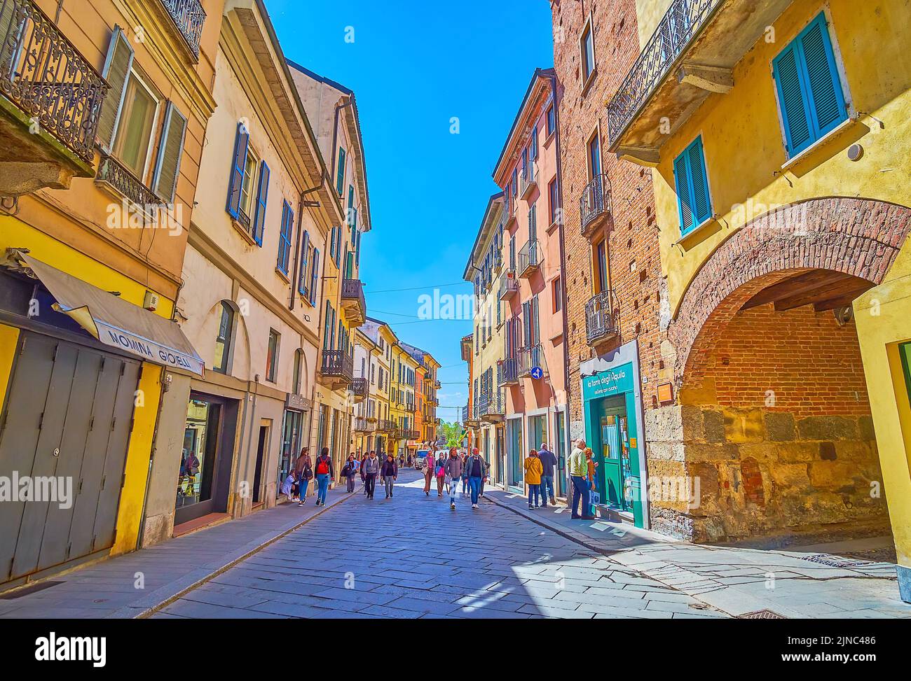 PAVIA, ITALY - APRIL 9, 2022: Strada Nuova is a modern street in the heart of old town with scenic medeival mansions, on April 9 in Pavia, Italy Stock Photo