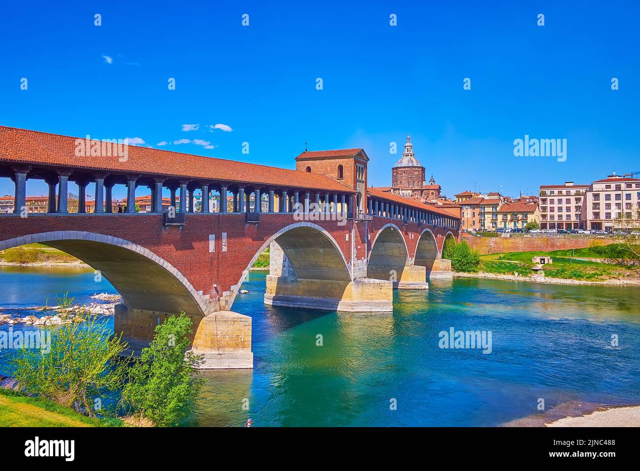 Medieval Pavia boasts reconstructed historical Ponte Coperto or Ponte Vecchio bridge across Ticino river, Italy Stock Photo